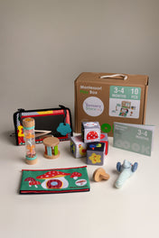 Collection of educational toys and materials for infants on a neutral background