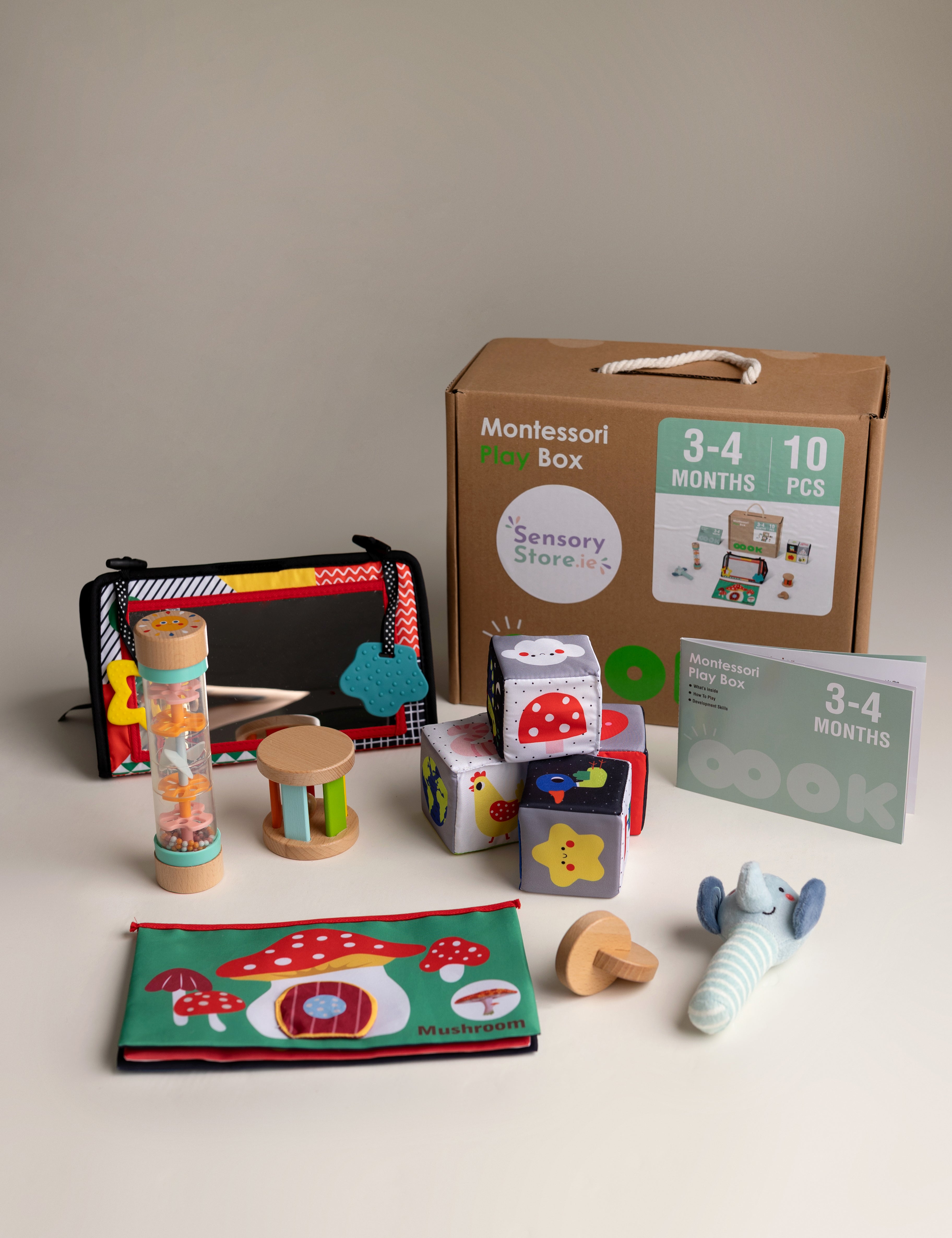 Collection of educational toys and materials for infants on a neutral background