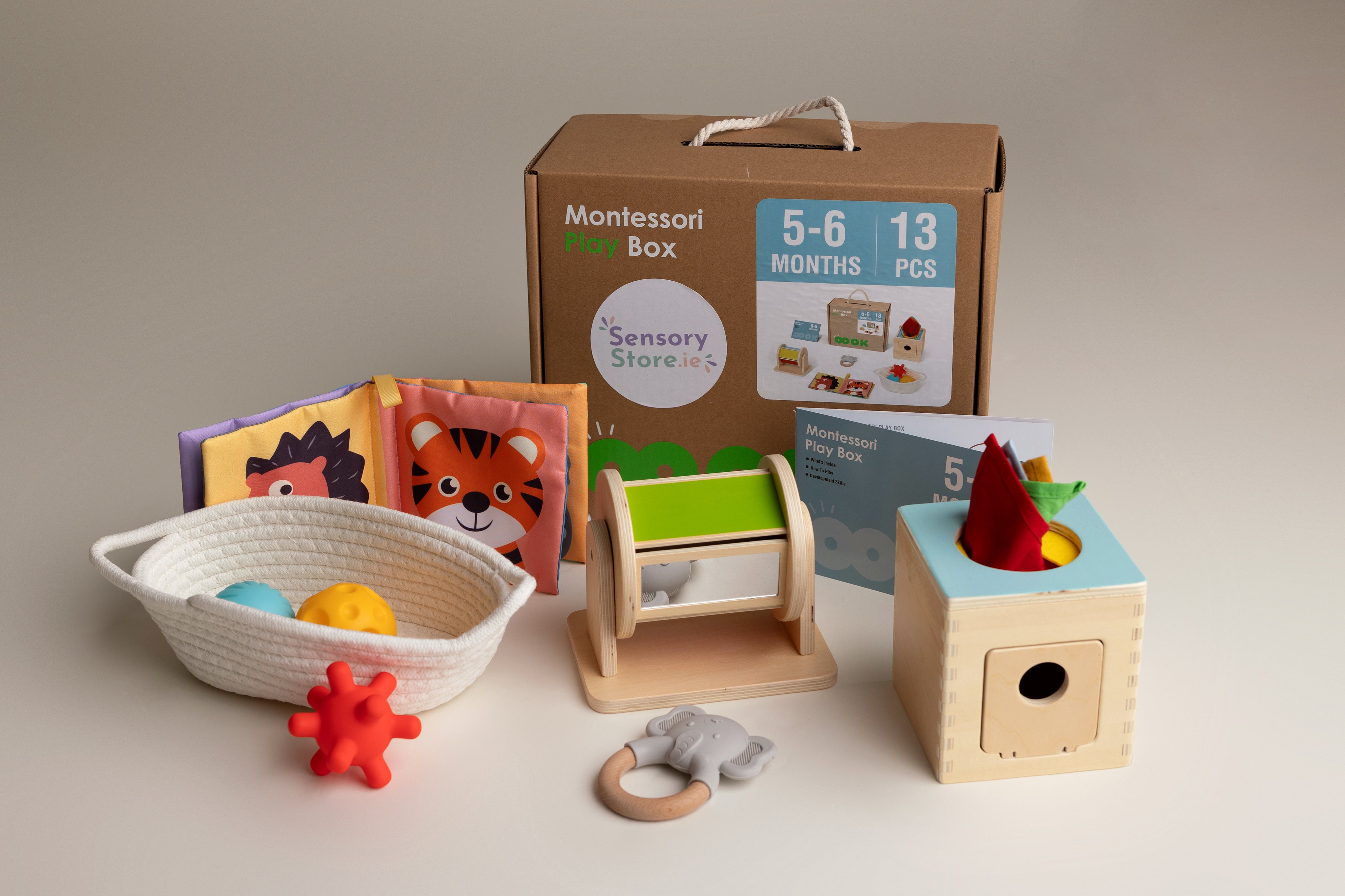 Collection of Montessori educational toys and materials on a neutral background suitable for a baby aged 5-6 months