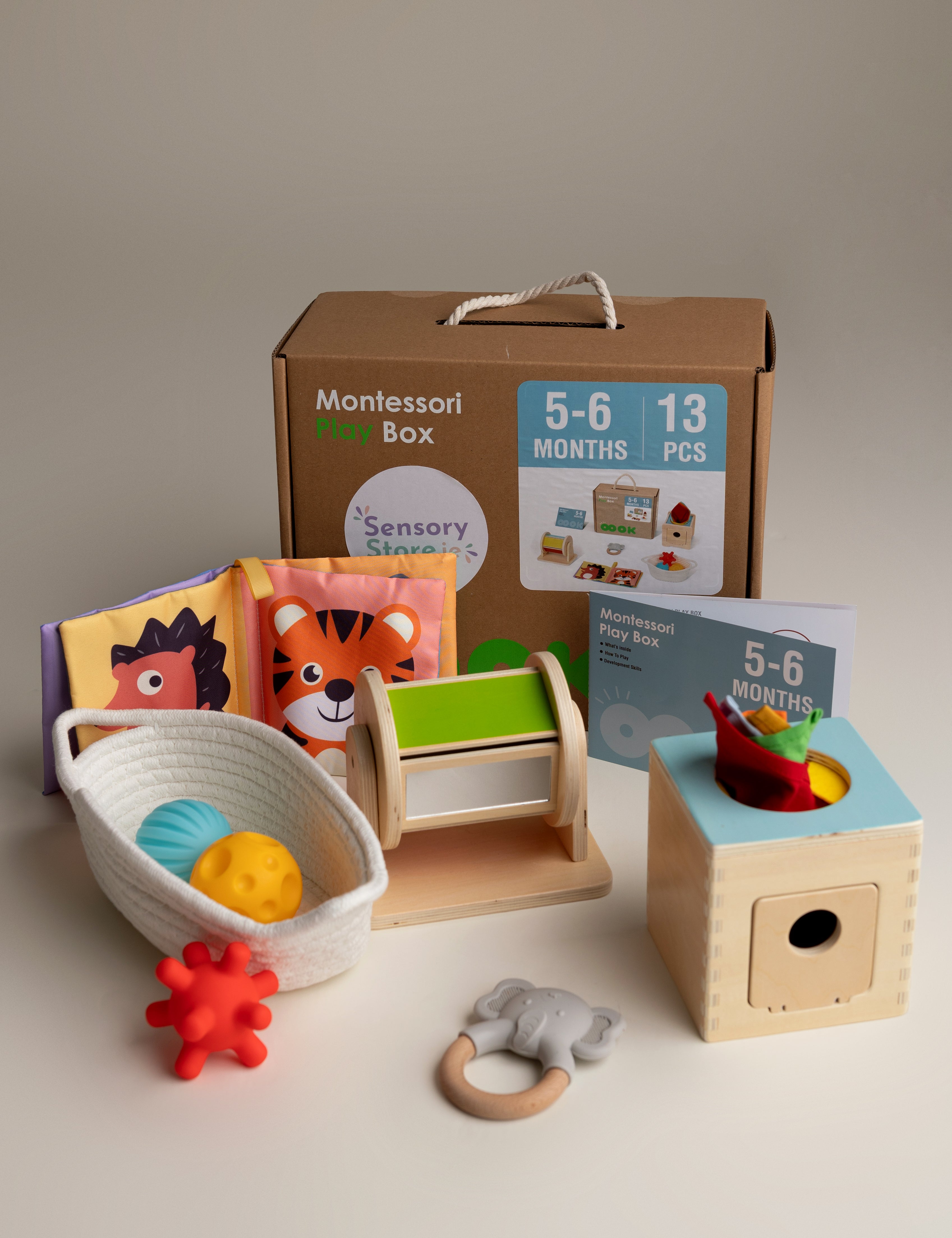 Collection of Montessori educational toys for a baby aged 5-6 months on a neutral background