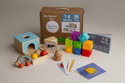 Montessori play box with educational toys and materials on a neutral background suitable for babies aged 7-8 months