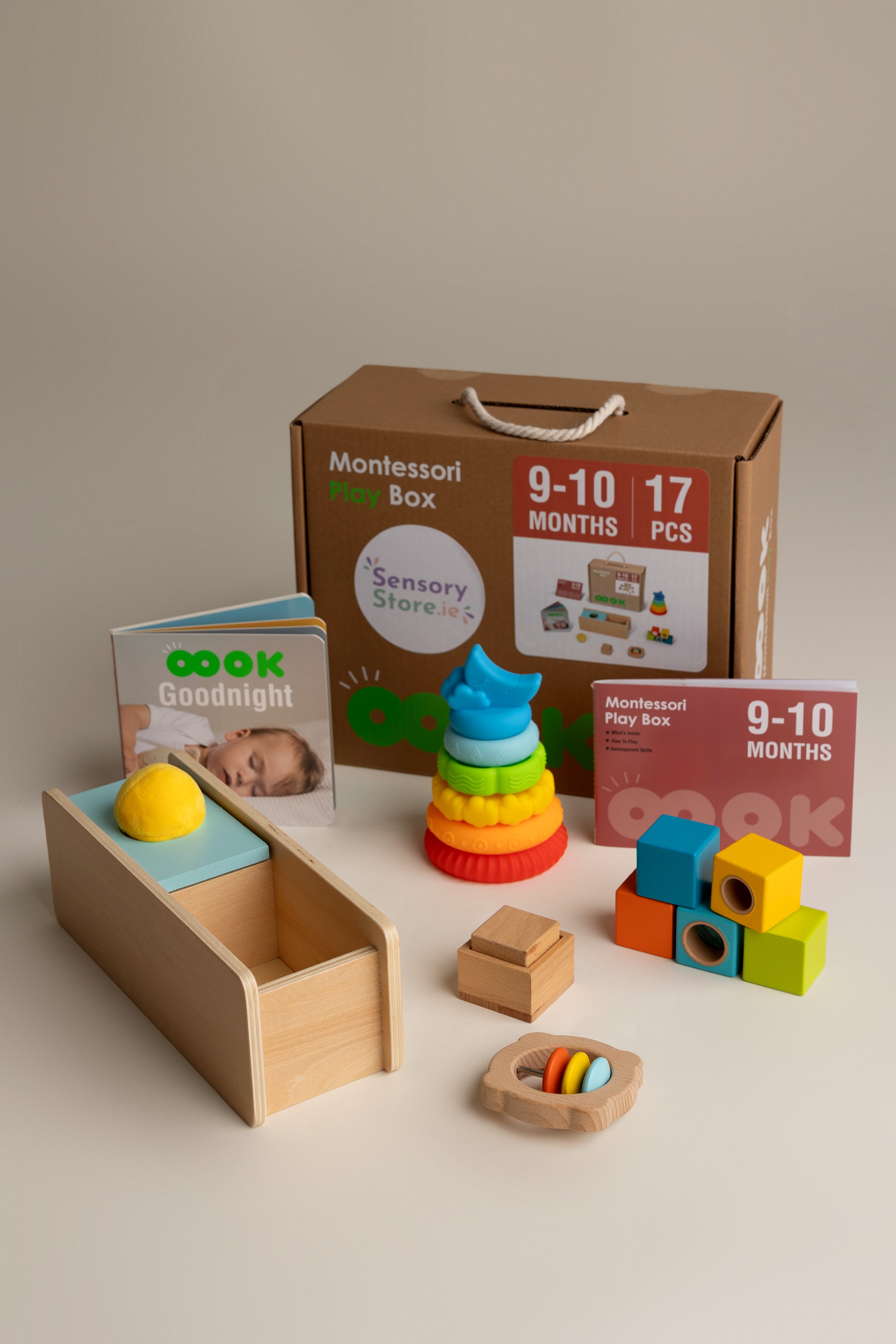 Montessori toy box aged 9-10 months with educational toys and materials on a neutral background