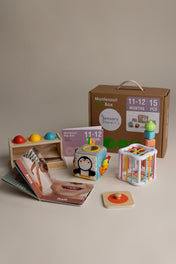 Montessori toy box with educational toys and materials on a neutral background
